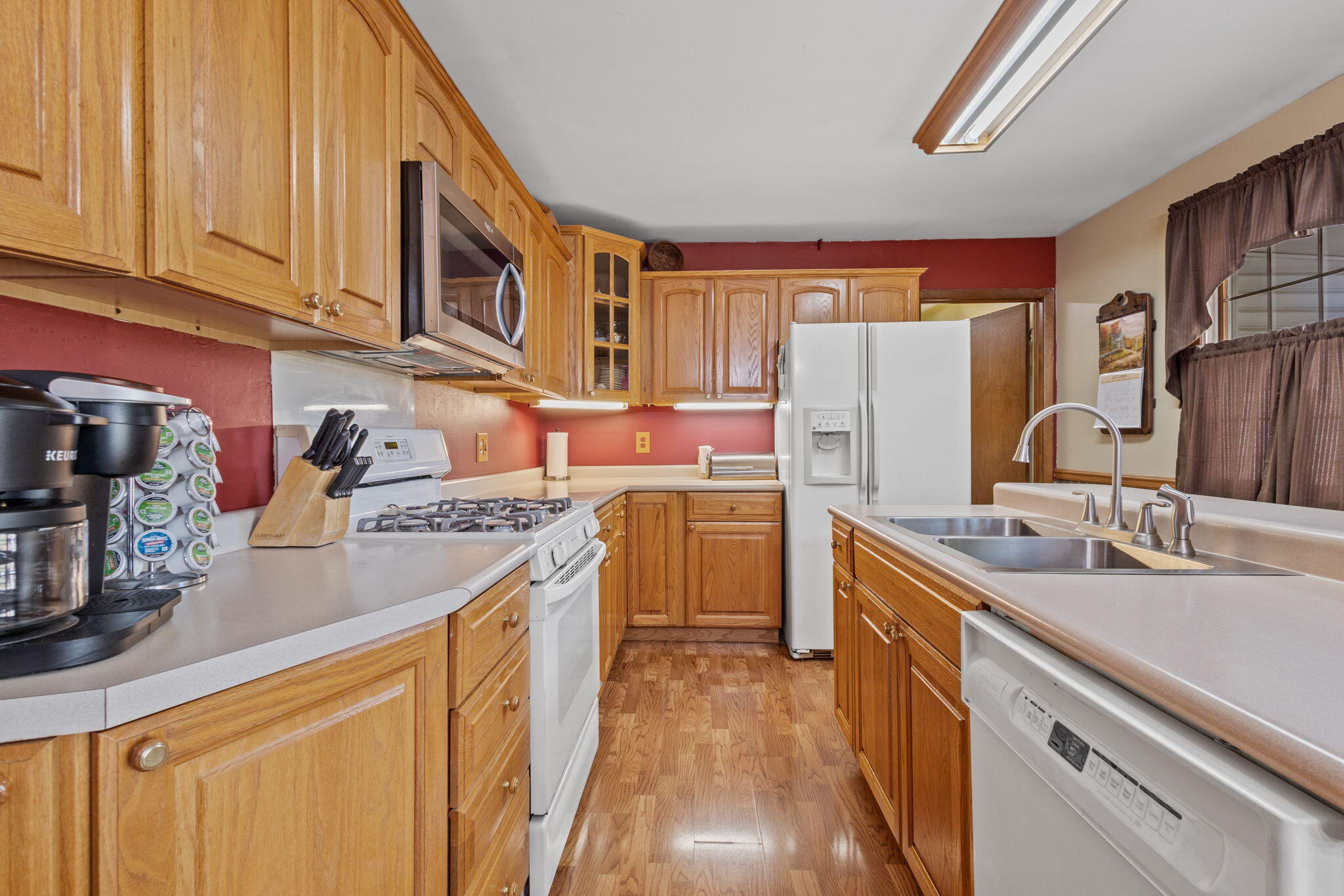 602 Forsythia Street Southeast De Motte, IN 46310 - Photo 6 of 16 a kitchen with a sink stove and refrigerator
