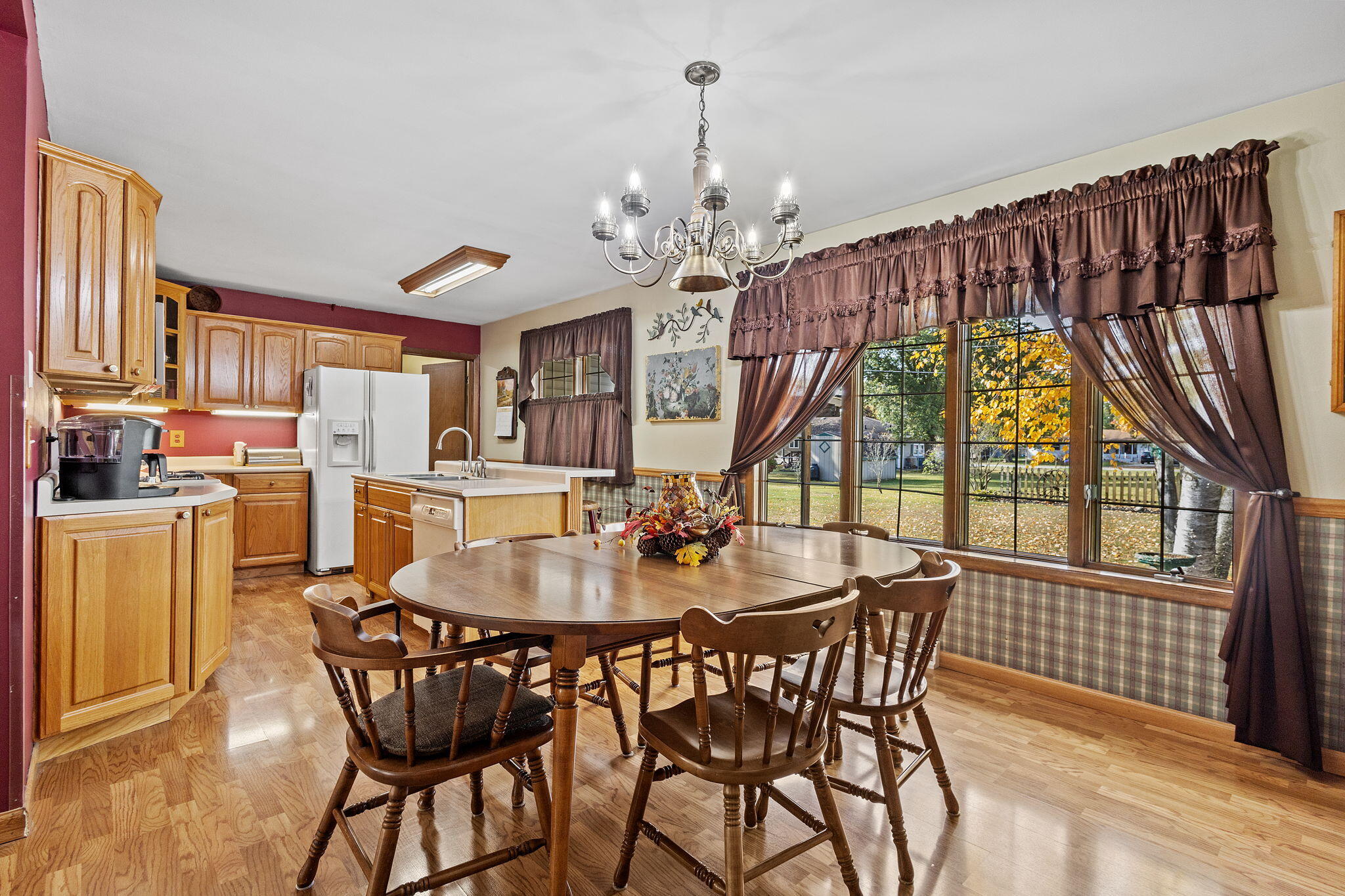 602 Forsythia Street Southeast De Motte, IN 46310 - Photo 8 of 16 a view of a dining room with furniture a chandelier and wooden floor