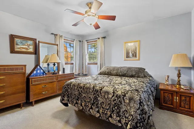 a bed room with a bed and a chandelier