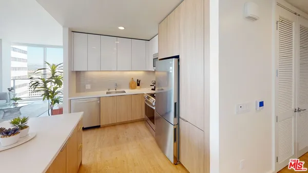 a kitchen with a refrigerator a sink and a stove