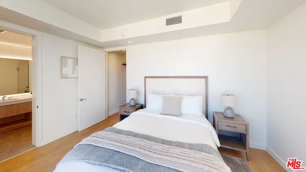 a bedroom with a bed and a table