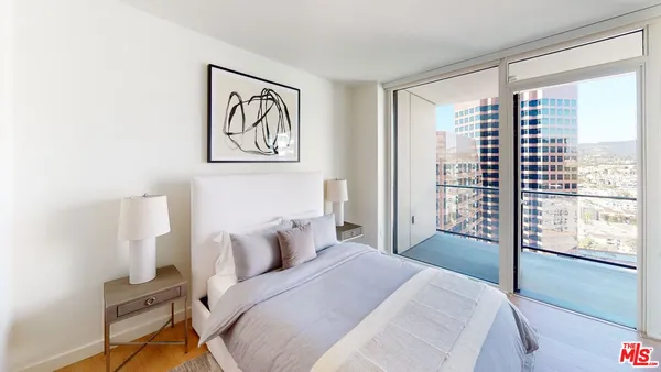 a bedroom with a bed and a large window