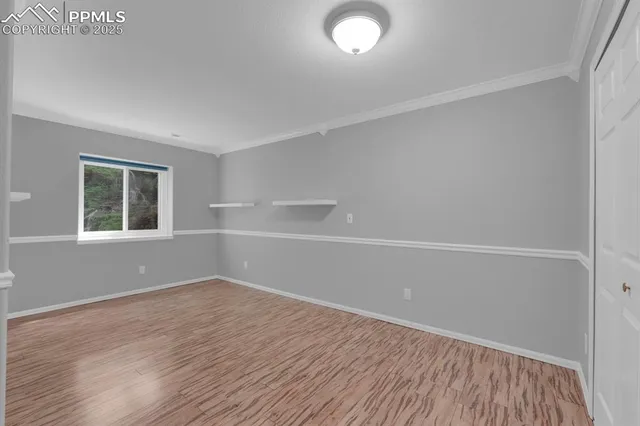 a view of an empty room with wooden floor