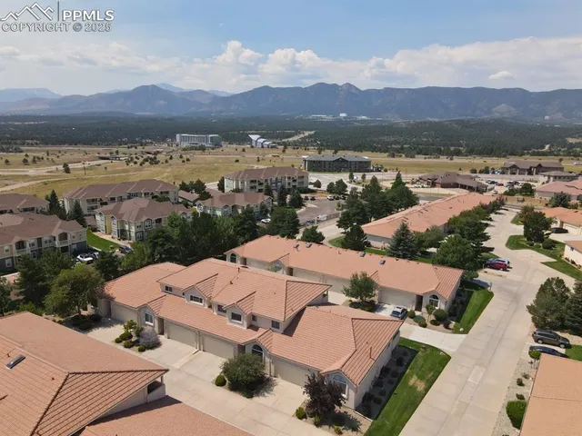 an aerial view of residential houses with outdoor space