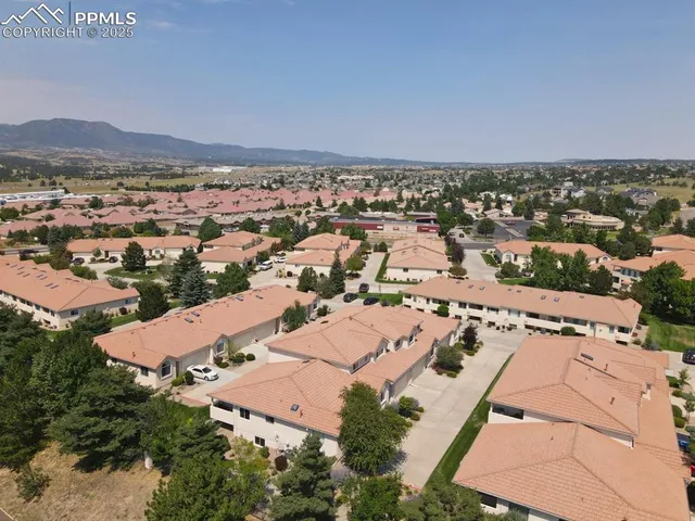 an aerial view of residential houses with outdoor space