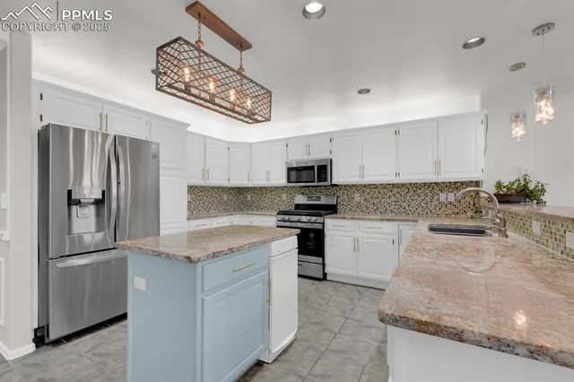 a kitchen with granite countertop stainless steel appliances and a counter space