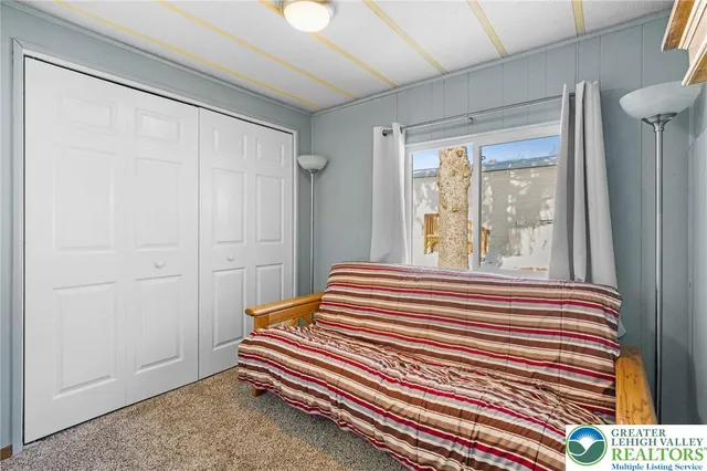 a view of a bedroom with wooden floor