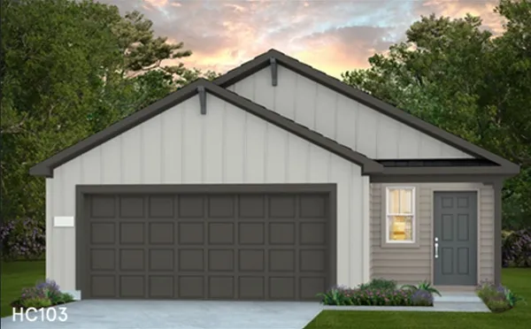 a view of house with garage and yard