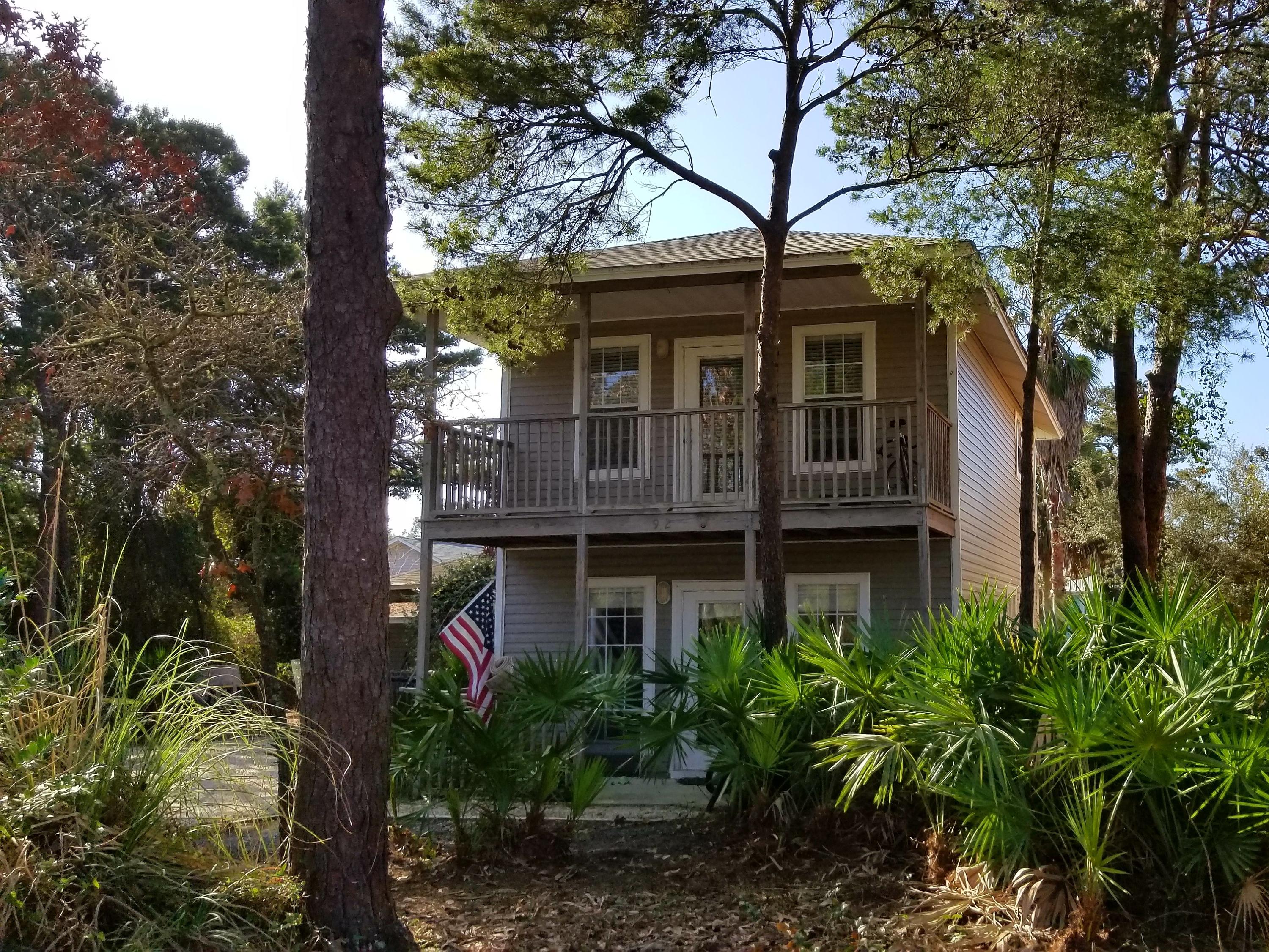 92 Bramble Street, Unit 92 Santa Rosa Beach, FL 32459 - Photo 1 of 14 a front view of a house with garden