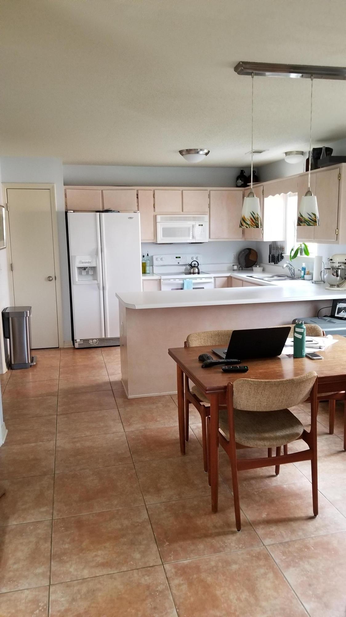 92 Bramble Street, Unit 92 Santa Rosa Beach, FL 32459 - Photo 2 of 14 a kitchen with kitchen island a sink table and chairs