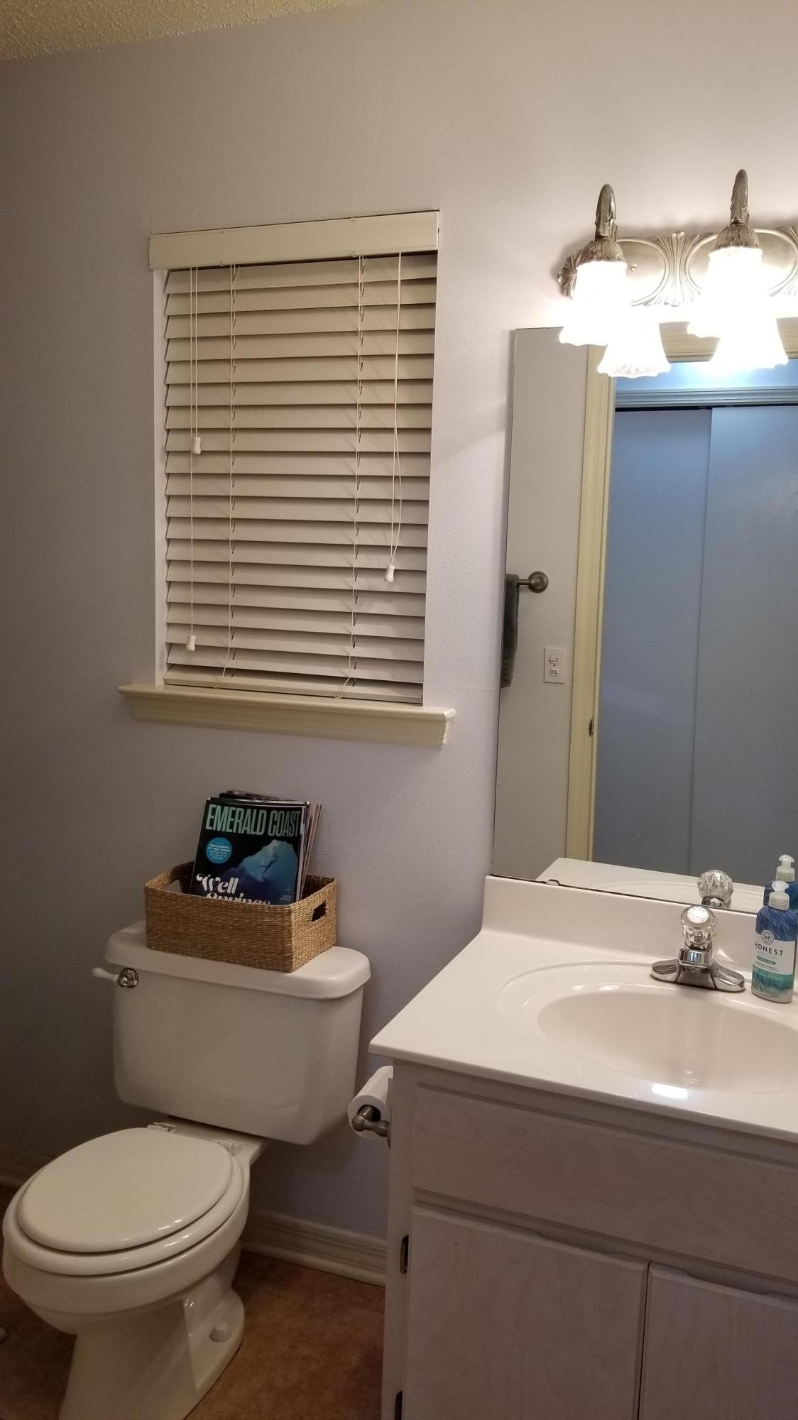 92 Bramble Street, Unit 92 Santa Rosa Beach, FL 32459 - Photo 4 of 14 a bathroom with a sink toilet a mirror and shower