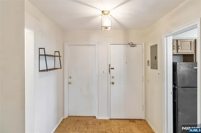 a view of an empty room with wooden floor