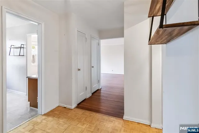 a view of a room with wooden floor and ceiling fan