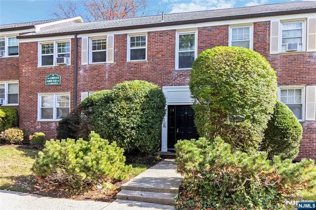 a view of a brick house with a yard