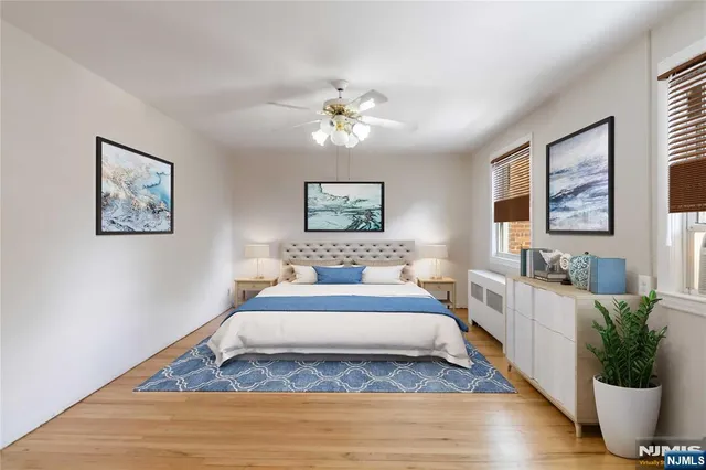 a spacious bedroom with a bed and a chandelier