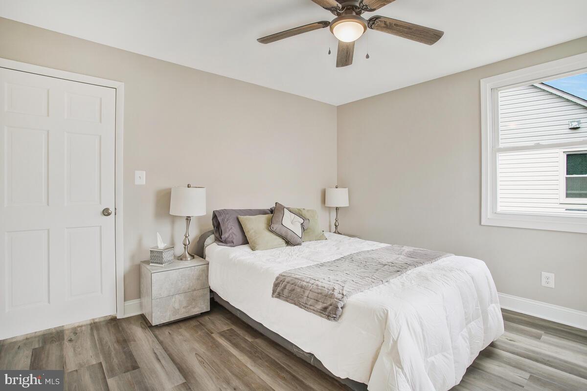 71 Del Rio Road Dundalk, MD 21222 - Photo 13 of 37 a bedroom with a large bed and a ceiling fan