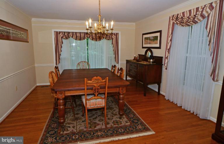 2010 Roundhouse Road Vienna, VA 22181 - Photo 6 of 30 a dining room with furniture a rug a rug and a chandelier
