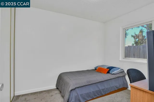 a bedroom with a bed and window