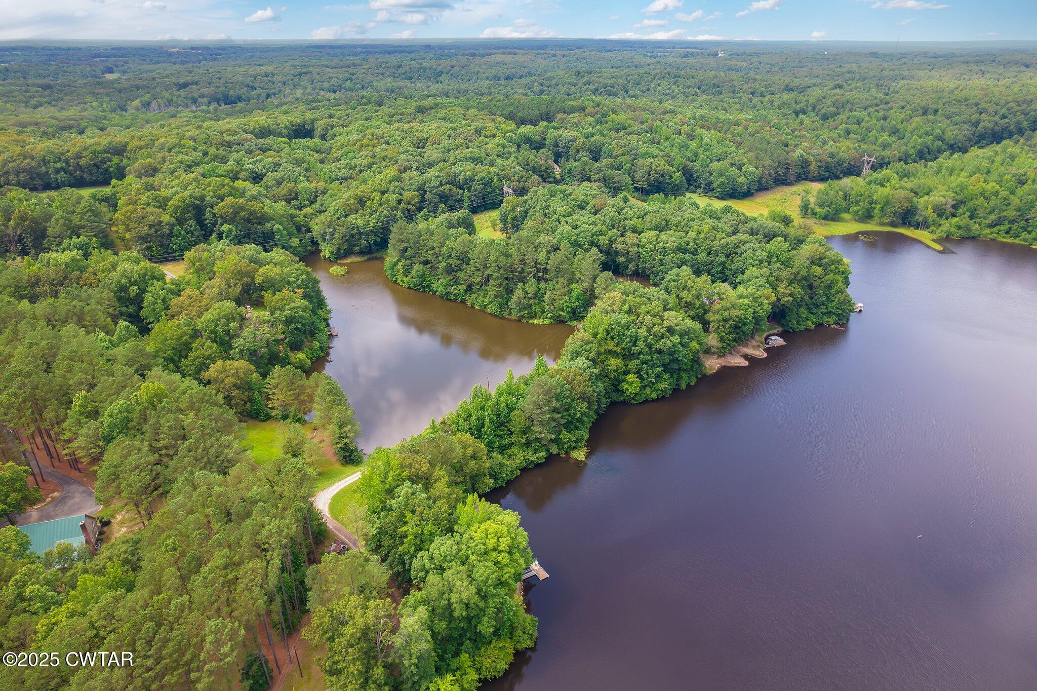 0 Liberty Claybrook Road Beech Bluff, TN 38313 - Photo 12 of 22 an aerial view of a house with a yard and lake view