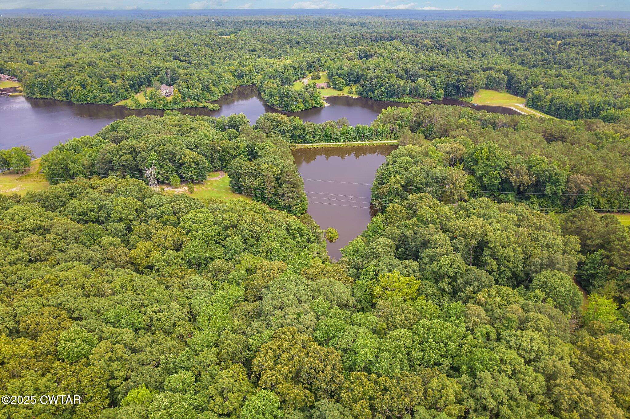 0 Liberty Claybrook Road Beech Bluff, TN 38313 - Photo 16 of 22 an aerial view of residential houses with outdoor space and trees