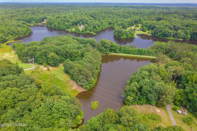an aerial view of residential houses with outdoor space and street view