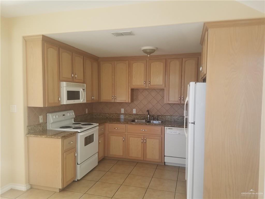 1208 West Wisconsin Road, Unit C Edinburg, TX 78539 - Photo 2 of 16 a kitchen with a stove sink and cabinets