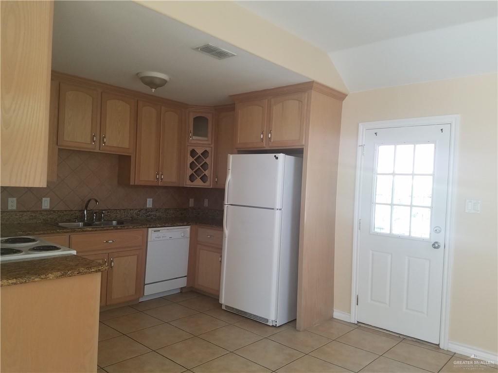 1208 West Wisconsin Road, Unit C Edinburg, TX 78539 - Photo 3 of 16 a kitchen with a refrigerator sink and cabinets