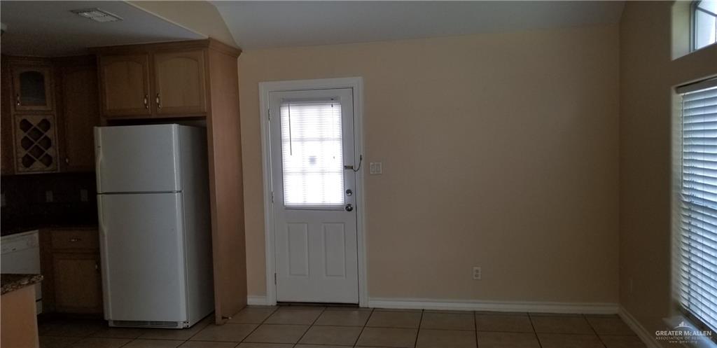 1208 West Wisconsin Road, Unit C Edinburg, TX 78539 - Photo 7 of 16 a view of a kitchen with refrigerator and cabinet