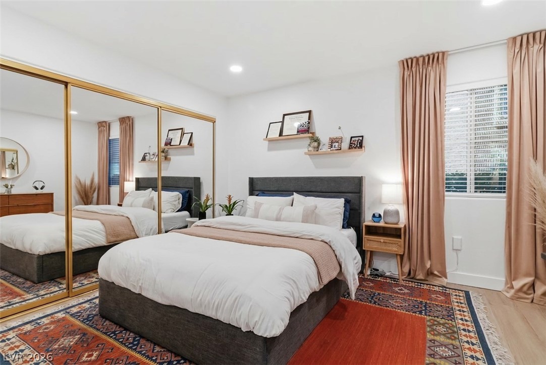 7950 West Flamingo Road, Unit 1180 Las Vegas, NV 89147 - Photo 19 of 26 Bright and airy, this sleeping space features ample natural light and a mirrored wardrobe.