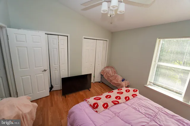 a bedroom with a bed and hallway