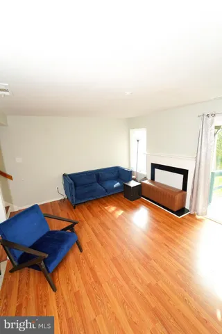 a bedroom with a bed and a lamp on dresser