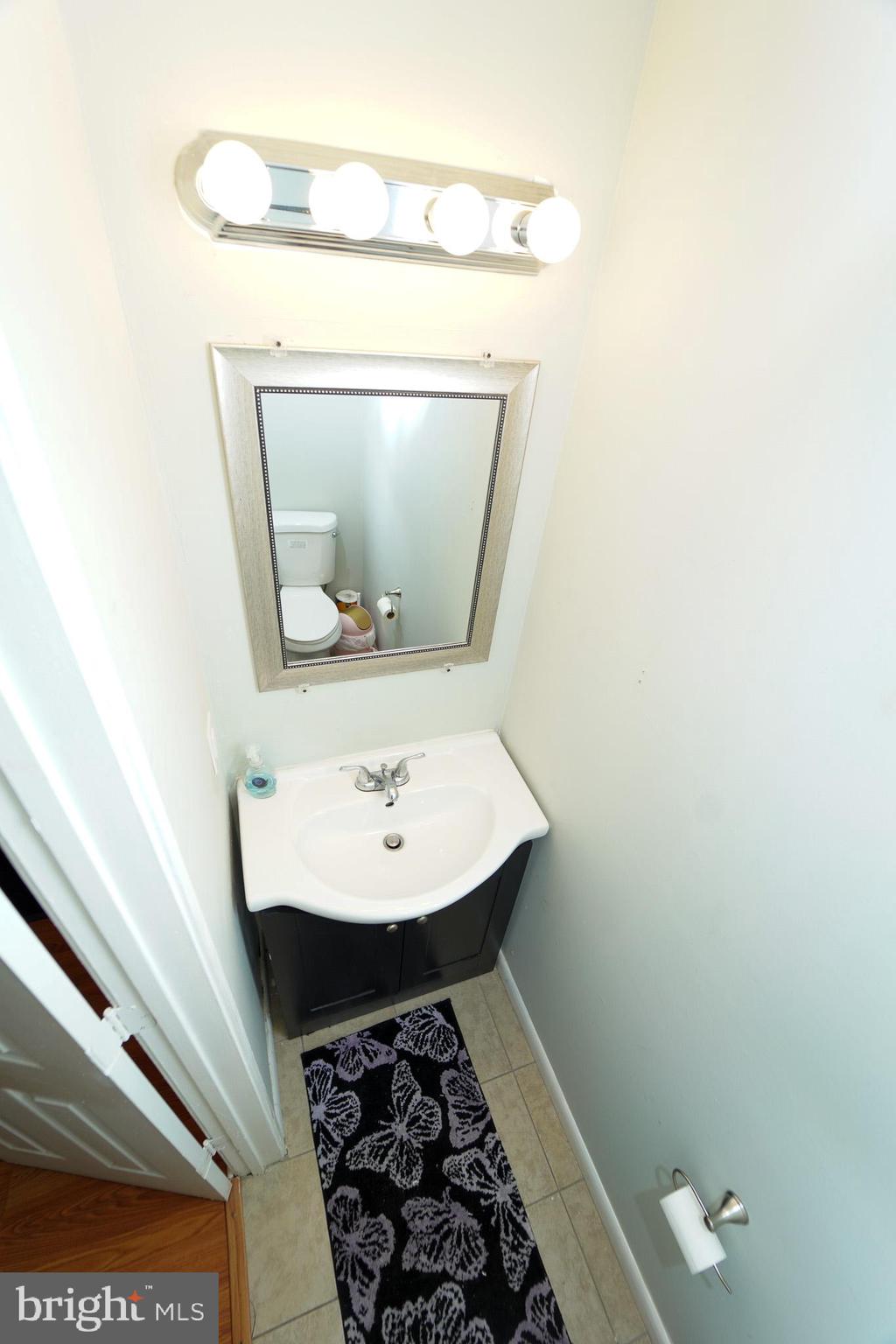 7 Brian Court New Castle, DE 19720 - Photo 6 of 17 a bathroom with a sink a toilet and mirror