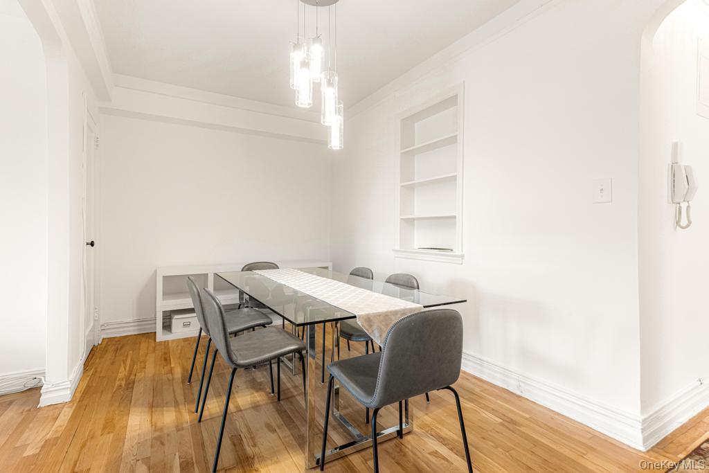 100-10 67th Road, Unit 6L Queens, NY 11375 - Photo 12 of 26 a view of a dining room with furniture and wooden floor