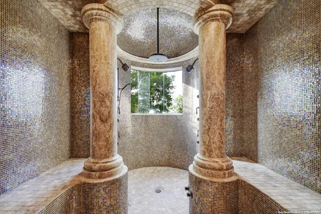 a view of walk in closet and bedroom with wooden floor