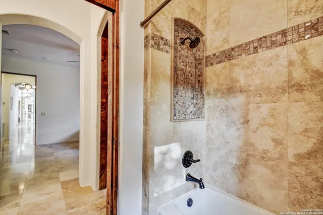 a spacious bedroom with a large bed and a large window