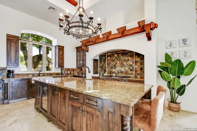 a kitchen with a sink a counter and cabinets