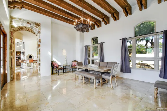 a dining room with furniture and a floor to ceiling window