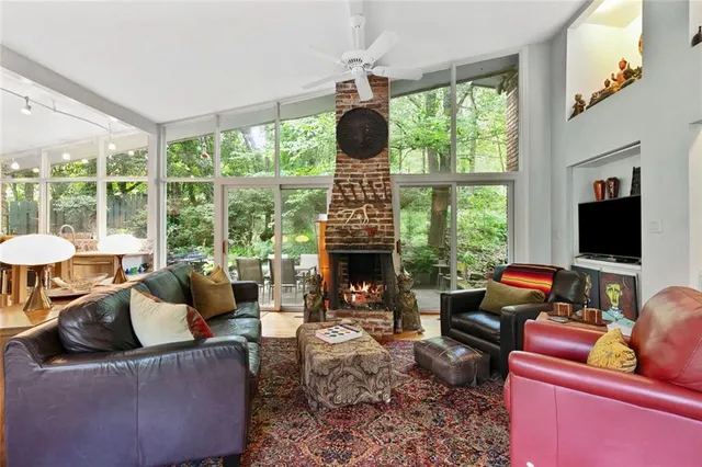 a living room with furniture tv and a large window
