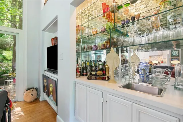 a kitchen with a sink and a mirror