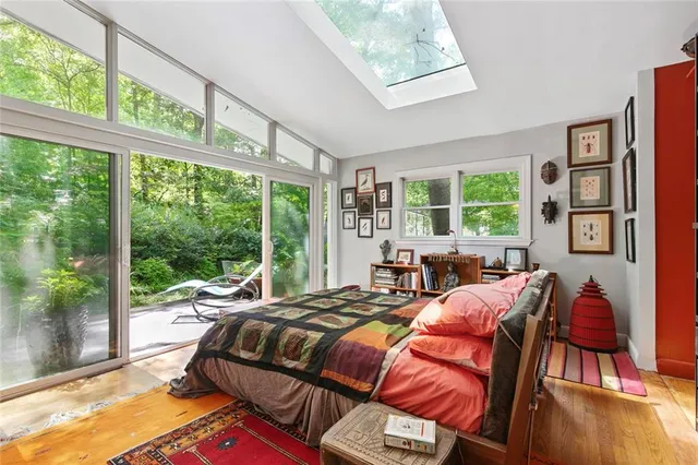 a bed sitting in a bedroom next to a window