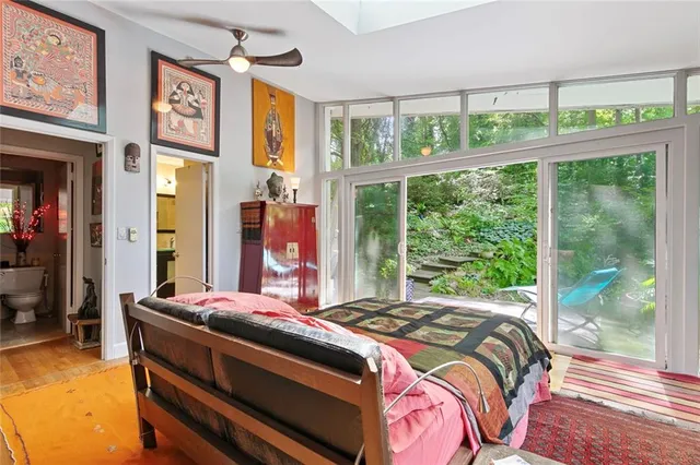 a bed sitting in a bedroom next to a window