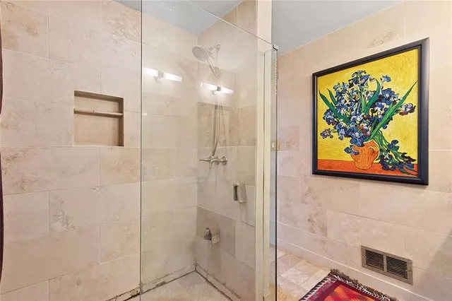 a bathroom with a painting on the wall and a shower