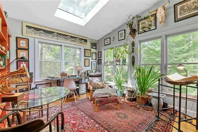 a living room filled with furniture and a large window