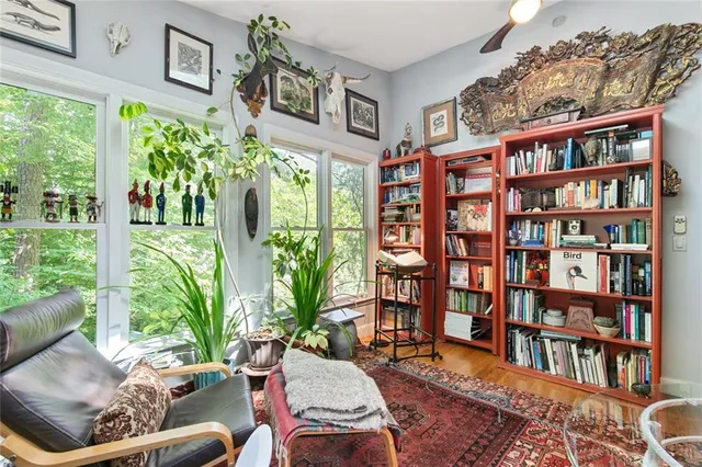 a living room filled with furniture and a book shelf