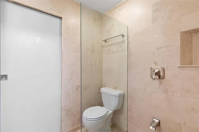 a white toilet sitting next to a bathroom sink