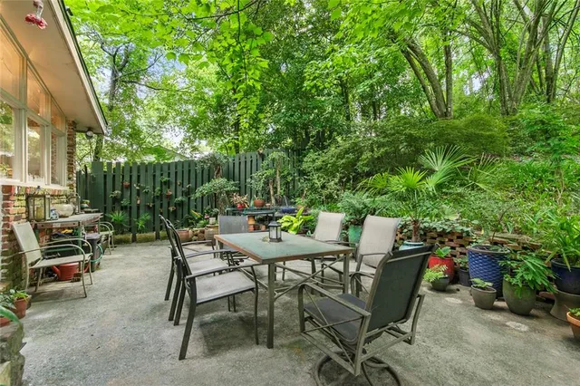 a view of a house with backyard sitting area and garden