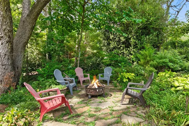 a backyard of a house with table and chairs