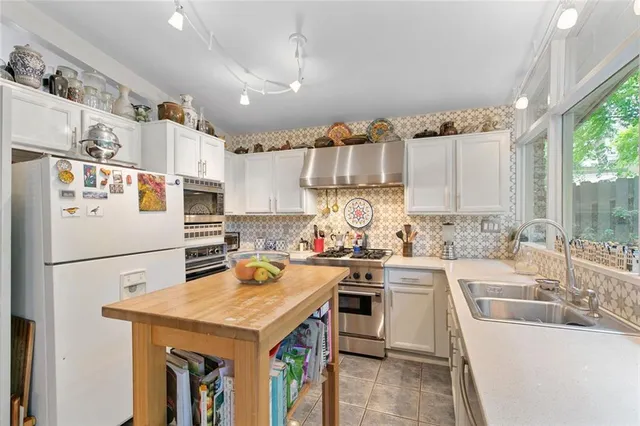 a kitchen with a sink a stove and refrigerator
