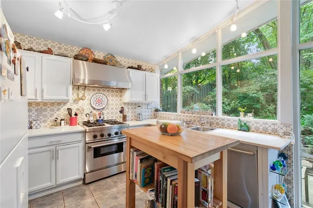 a kitchen with a stove a sink and a refrigerator
