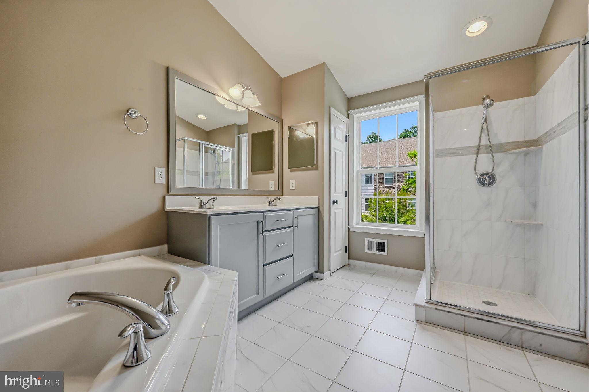 208 Jackdaw Alley, Unit 208 Springfield, PA 19064 - Photo 44 of 49 a bathroom with a tub sink and mirror